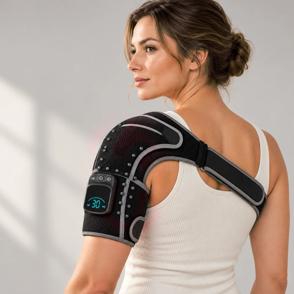 Woman wearing the ArcLuma shoulder wrap with the lights off