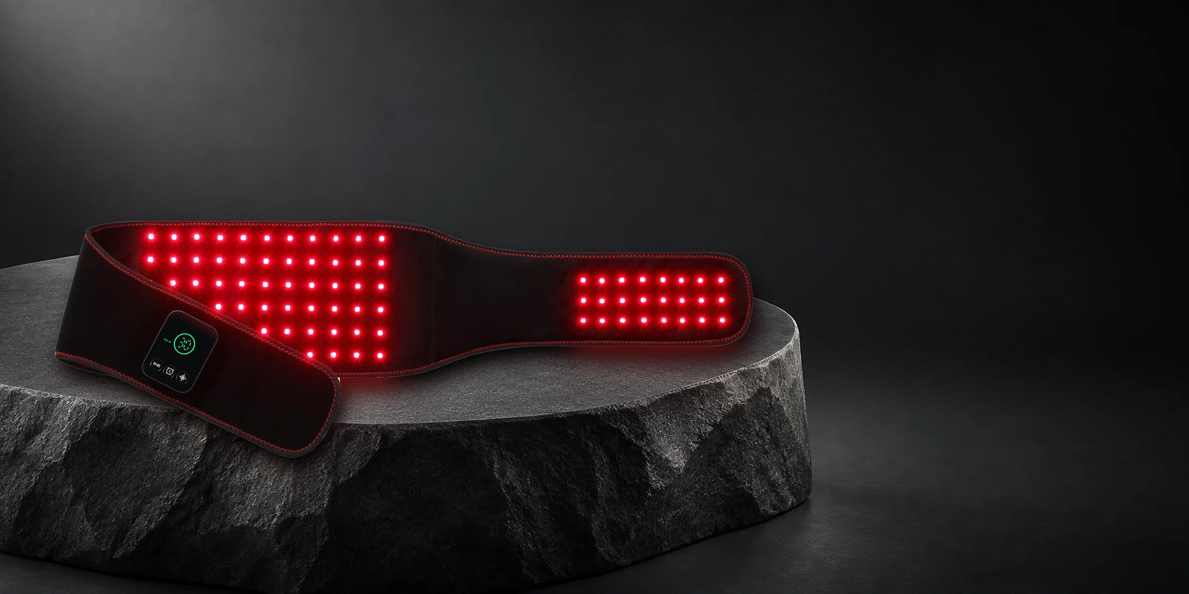 SlimLuma belt illuminated with red light on a dark stone platform